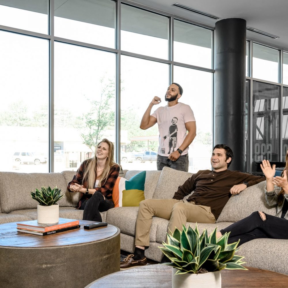 Apartments for Rent Denver CO - A Group of Residents Enjoy the DECO Apartments Resident Lounge