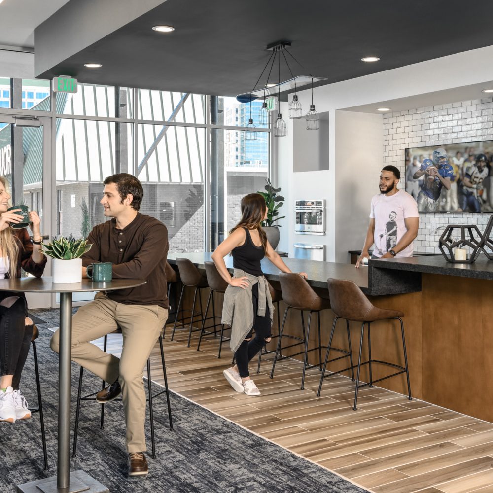 Green Friendly Apartments in Denver, CO - DECO Apartments Club Room With Bar Tables and Chairs